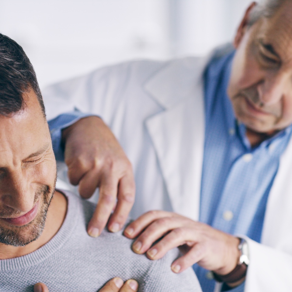 Man, doctor or shoulder pain with checkup for muscle tension, relief or exam at hospital. Mature, male person or medical professional with client for ache, inflammation or injury at healthcare clinic.