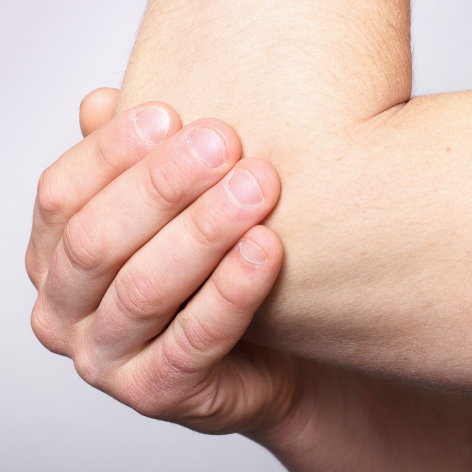 man demonstrated elbow pain