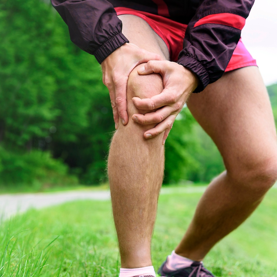 Running injury - Man out jogging with knee pain