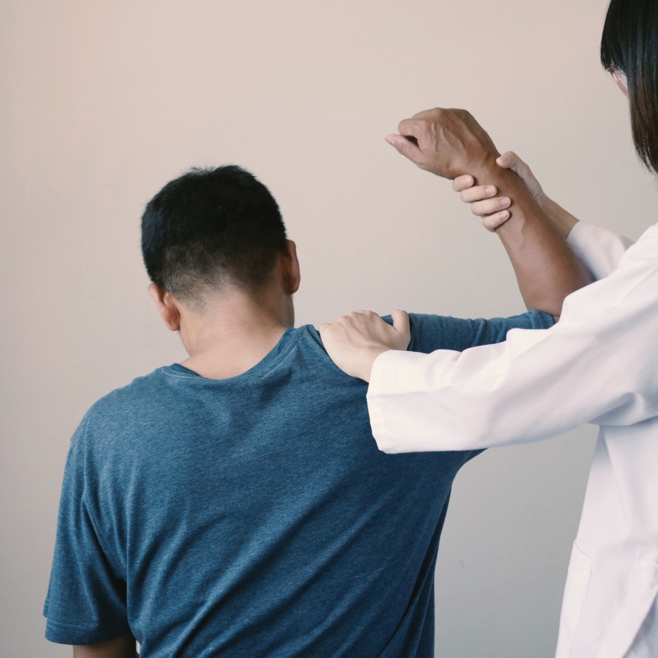 A male Asian patient received physical therapy for chronic, severe pain with a physical therapist specializing in pain management in a hospital setting.