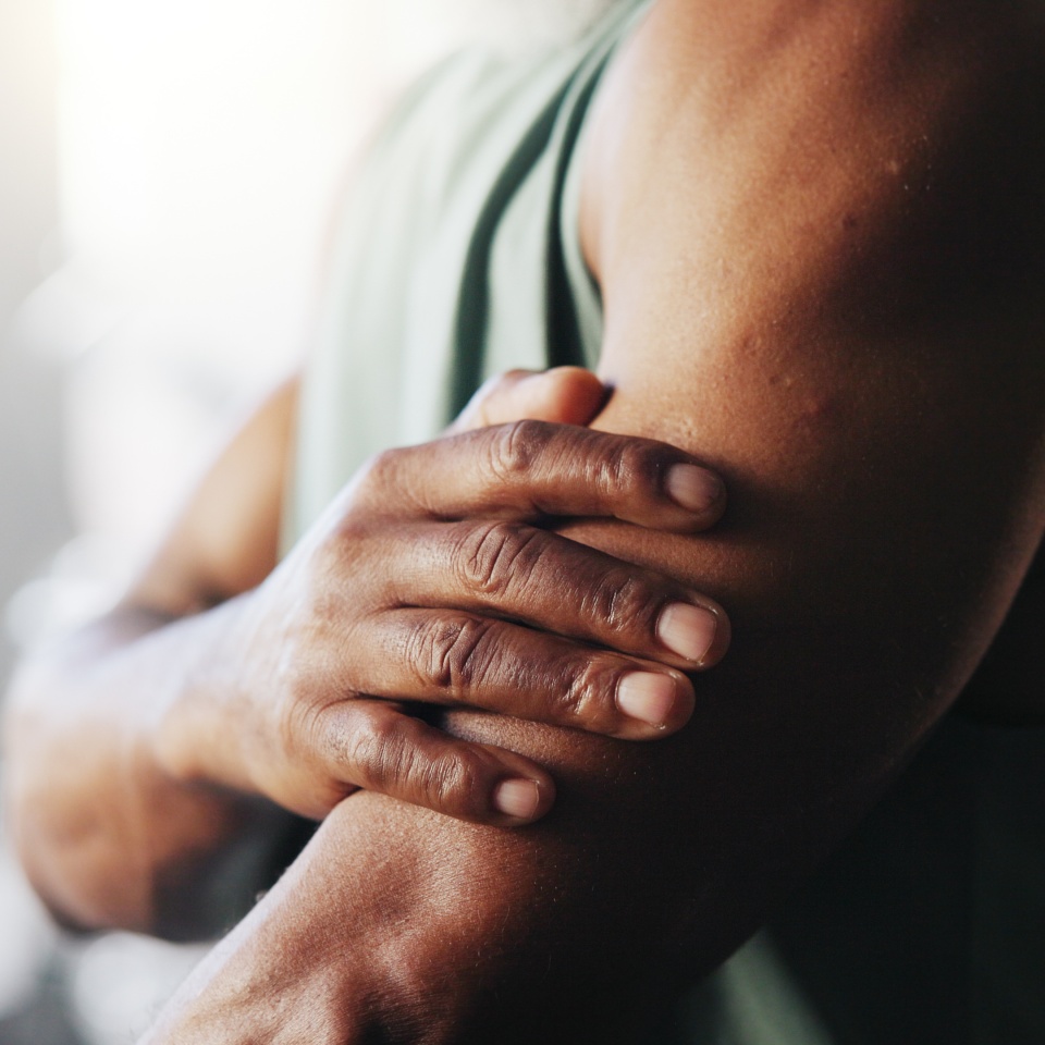 Exercise, injury and arm of man in gym for muscle fatigue, inflammation and accident in training. Sports center, health and person with sprain, hurt and pain for fitness, workout and wellness.