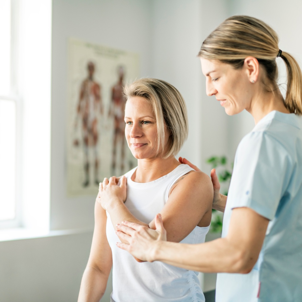 Modern rehabilitation physiotherapy worker with woman client