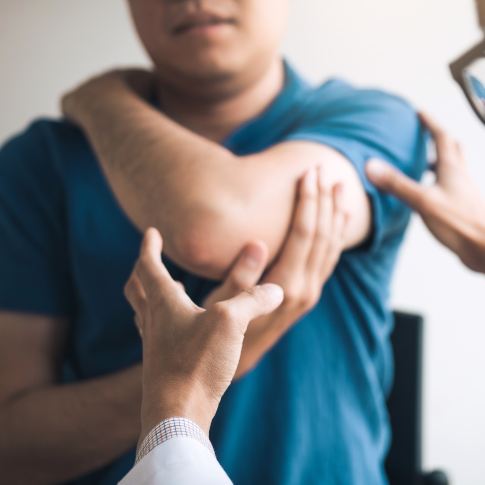 Physical therapists are checking patients elbows at the clinic office room.
