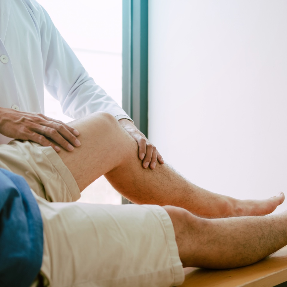 Physical therapists are using the handle to the patient knee to check for pain.
