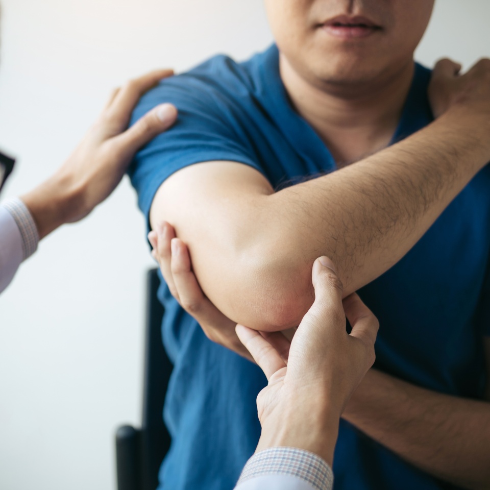 Physical therapists are checking patients elbows at the clinic office room.