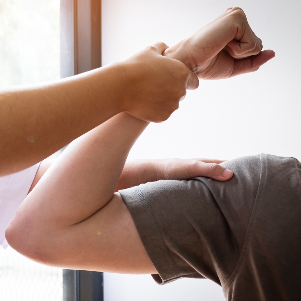 Therapist treating test the strength of the biceps muscle of male patient, Physical therapy concept.