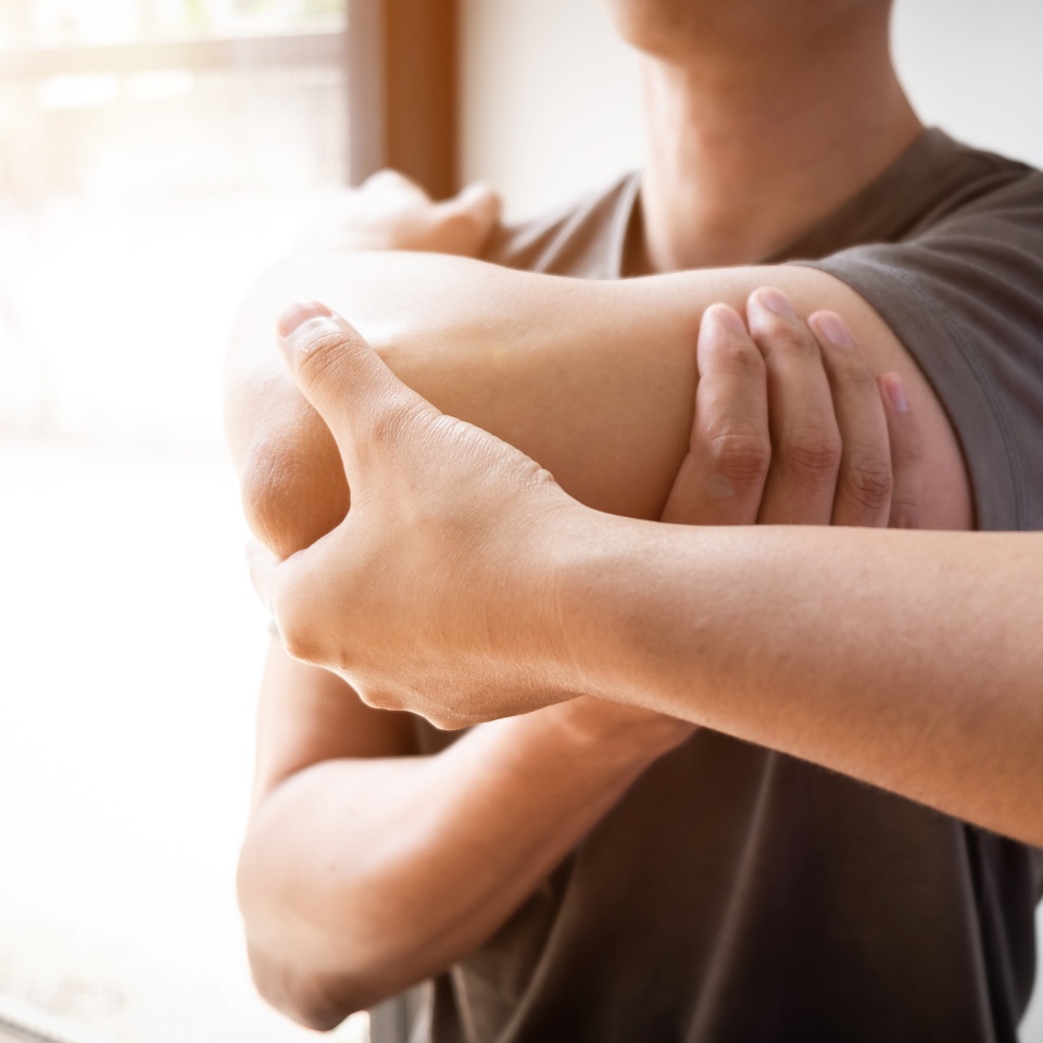 Therapist treating a male injured by rotator cuff stretching method, Physical therapy concept.
