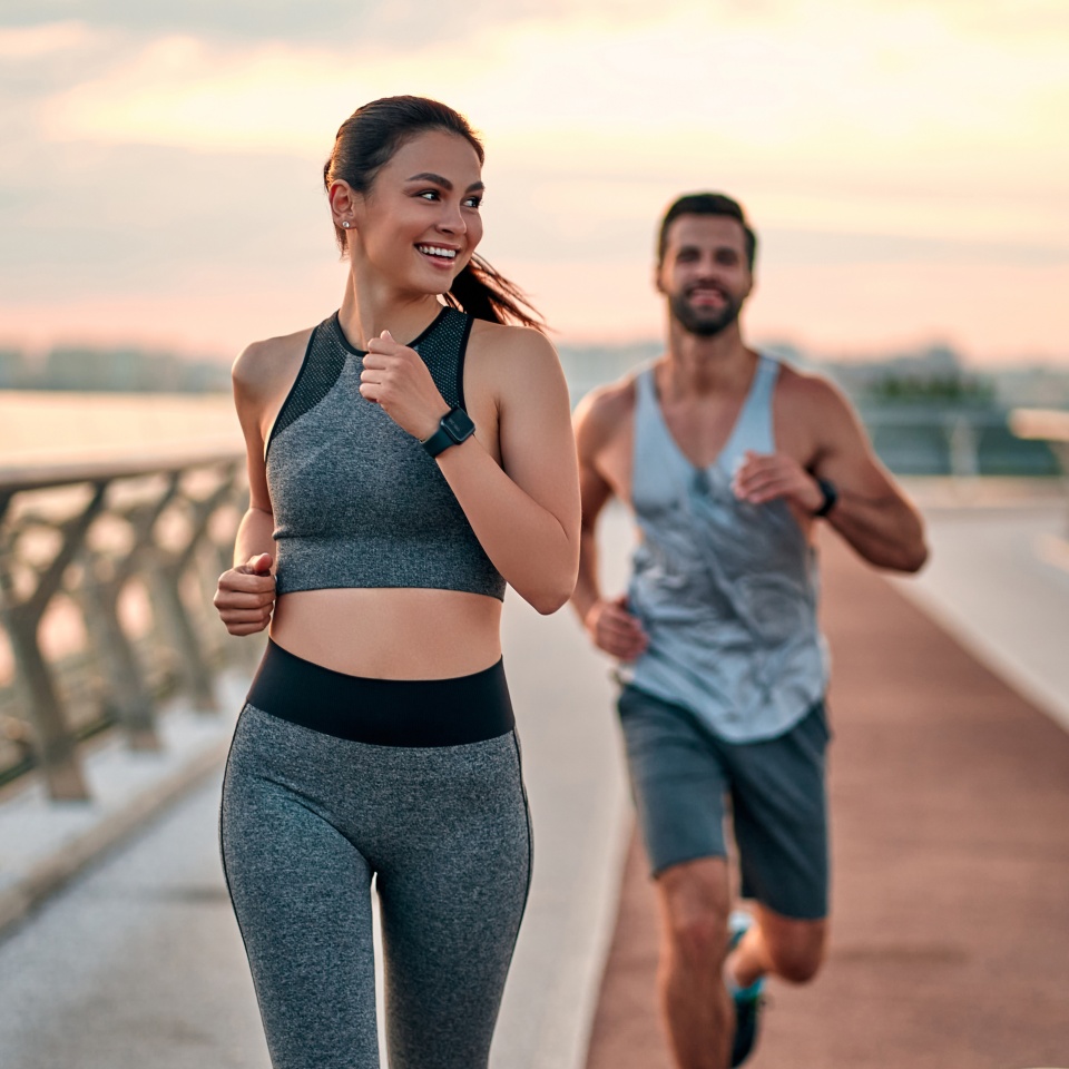 Couple doing sport together on the street. Morning run