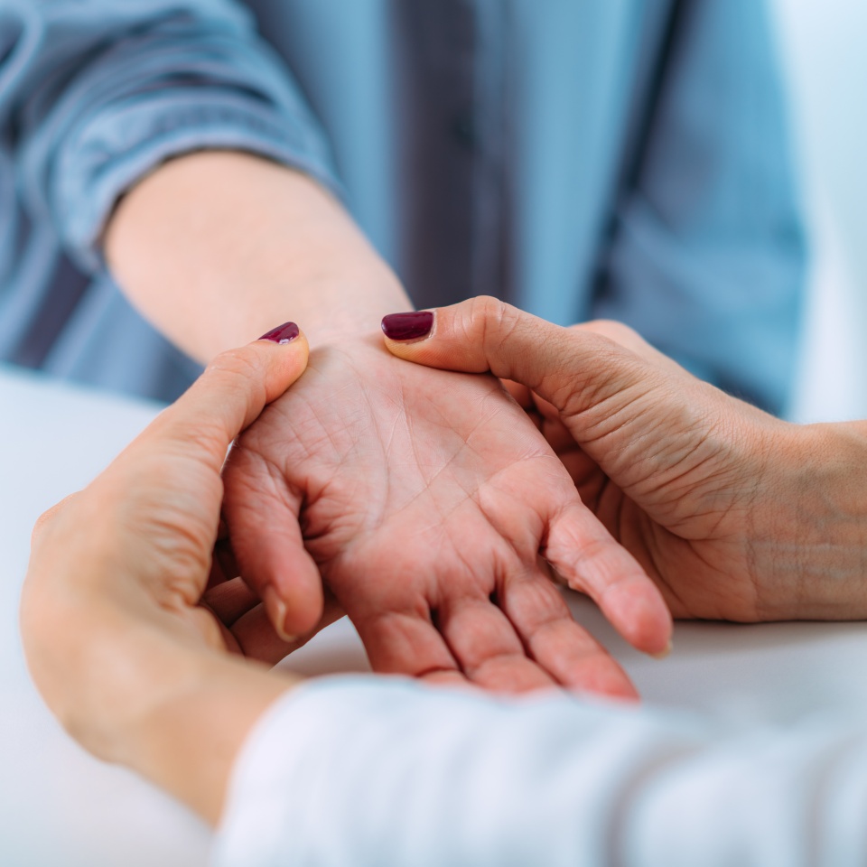 Examining the hand of a senior patient with carpal tunnel syndrome. Close-up image of senior woman’s wrist.