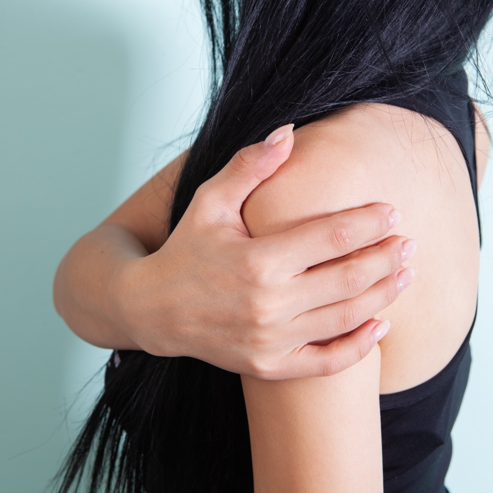 young woman has shoulder pain