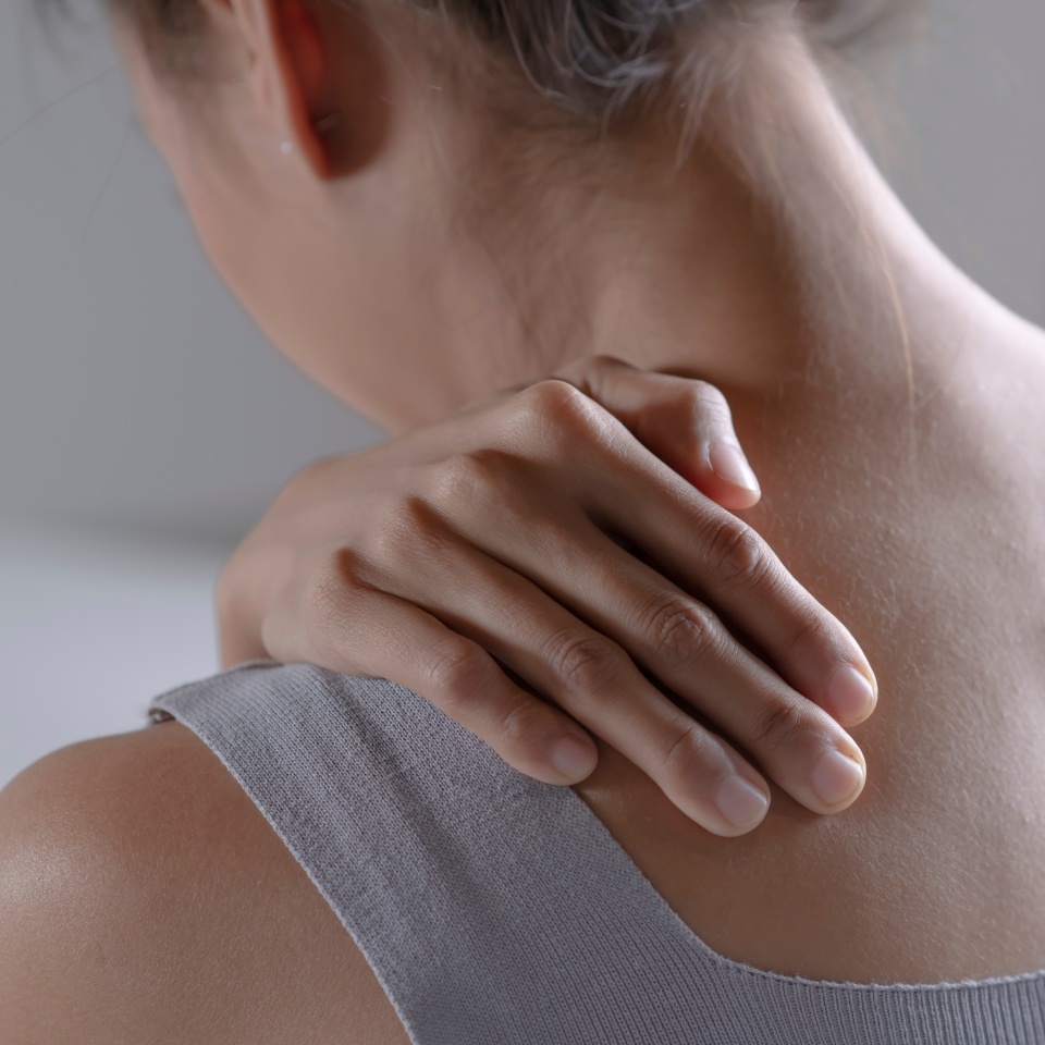 Asian woman has shoulder pain. Female holding painful shoulder with another hand. People with body-muscles problem, Healthcare And Medicine.