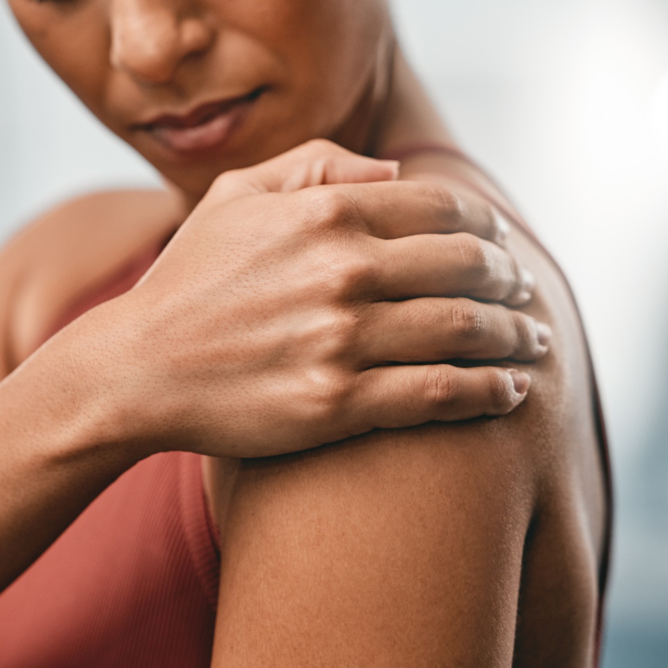 Closeup, fitness and black woman with shoulder pain, muscle ache and strain after training, workout and inflammation. African American lady, female and athlete with sports accident, torn and bruised.