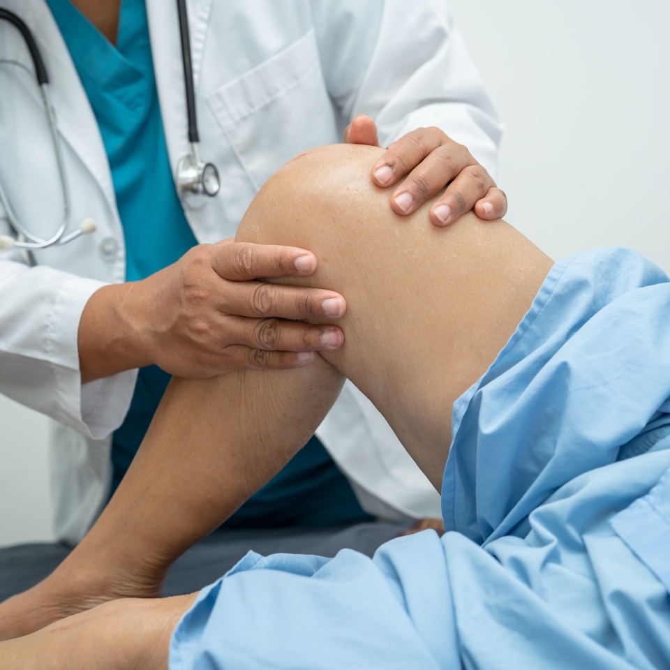 Asian elderly woman patient show her scars surgical total knee joint replacement Suture wound surgery arthroplasty on bed in hospital, healthy strong medical concept.