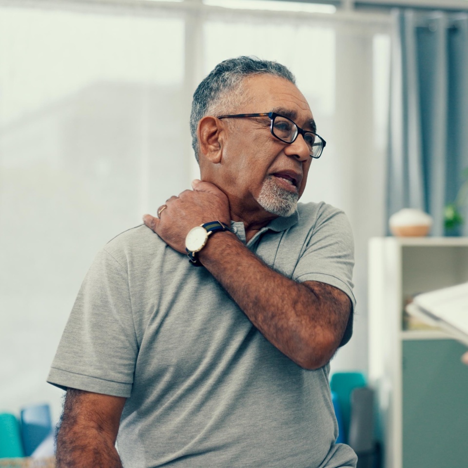 Tablet physiotherapy and senior patient for consultation with shoulder pain, injury and assessment in office. Doctor, physiotherapist and elderly man with muscle help, service and digital technology.
