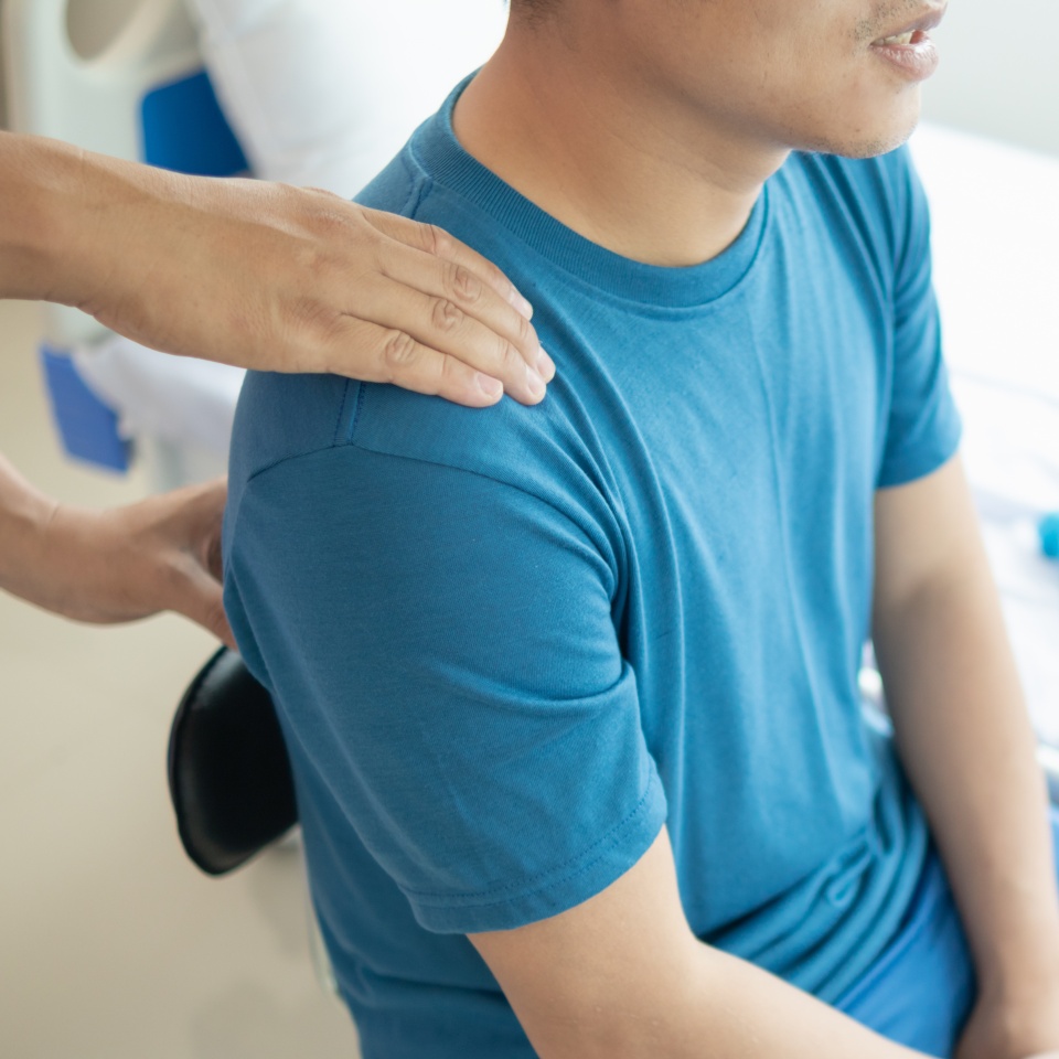 man was admitted for treatment of muscle pain in back of his shoulder due to working hard and causing muscle inflammation. doctor is treating man muscle pain in his back and shoulders due to overwork.