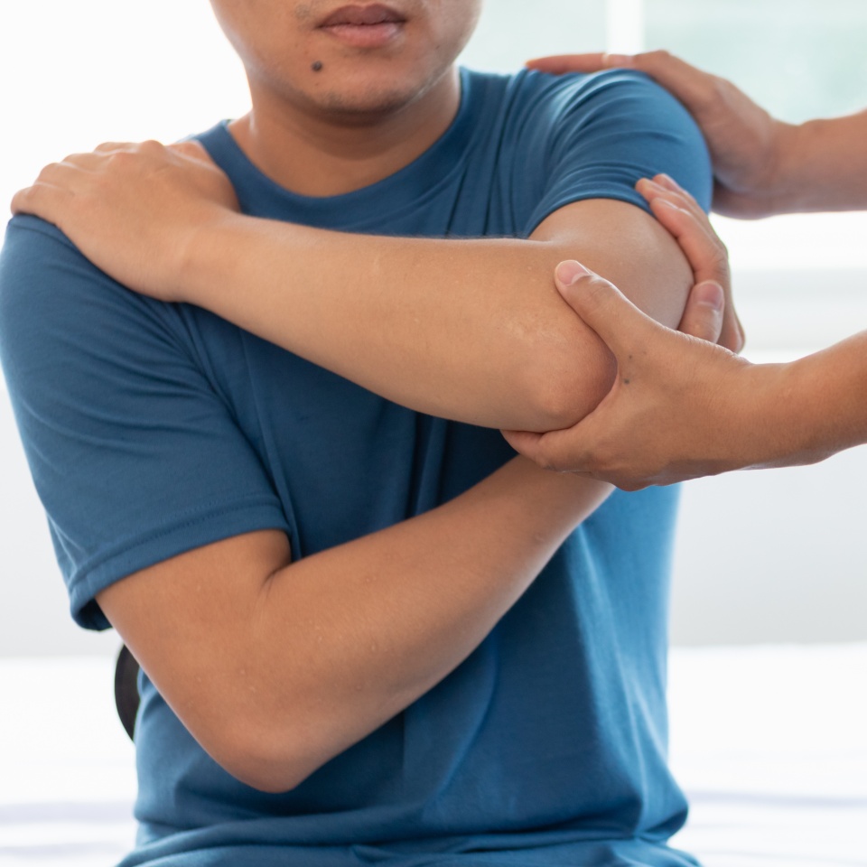 man was admitted for treatment of muscle pain in back of his shoulder due to working hard and causing muscle inflammation. doctor is treating man muscle pain in his back and shoulders due to overwork.