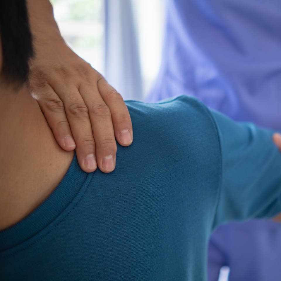 man was admitted for treatment of muscle pain in back of his shoulder due to working hard and causing muscle inflammation. doctor is treating man muscle pain in his back and shoulders due to overwork.