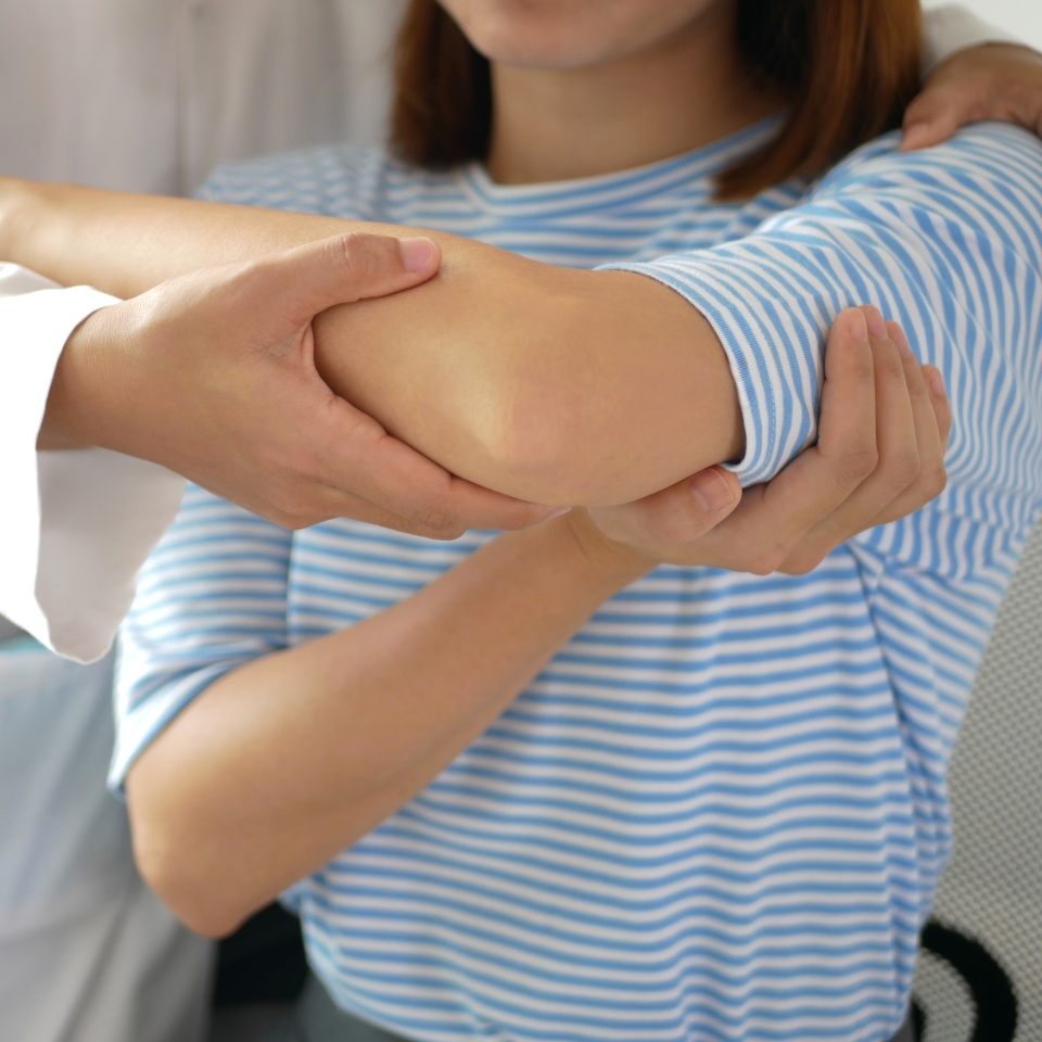 Asian female patient doing physical therapy with physical therapist Perform pain therapy in a hospital.