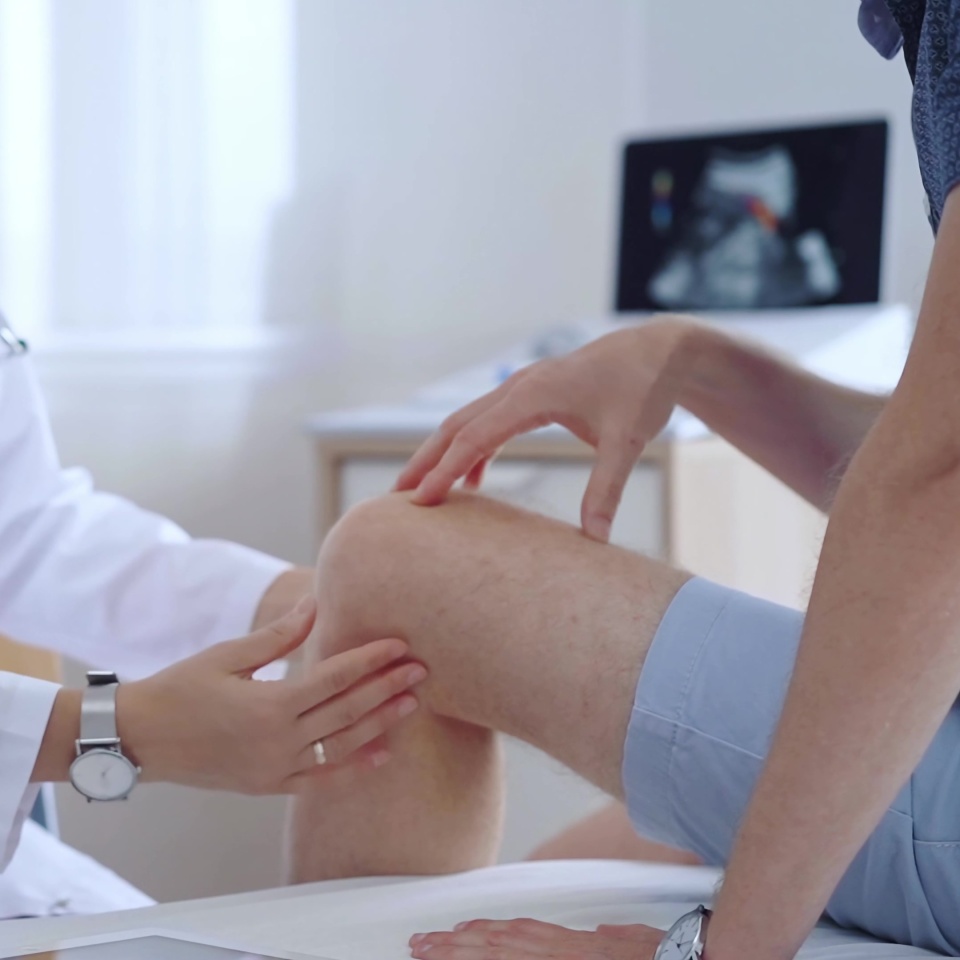 Doctor is carefully examining a patient's knee, providing personalized care and support. Medicine and orthopedic concept.