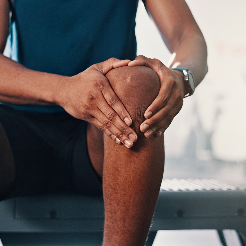 Gym, knee pain and man with fitness, leg injury and athlete with orthopedic issue or fibromyalgia emergency. Person, muscle tension or medical arthritis in joint with training or health club workout.
