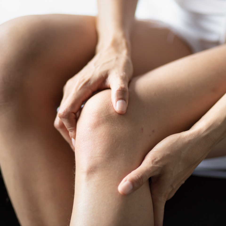Asian young woman having knee joint pain or knee injury problem, concept of knee joint surgery or orthopedics treatment